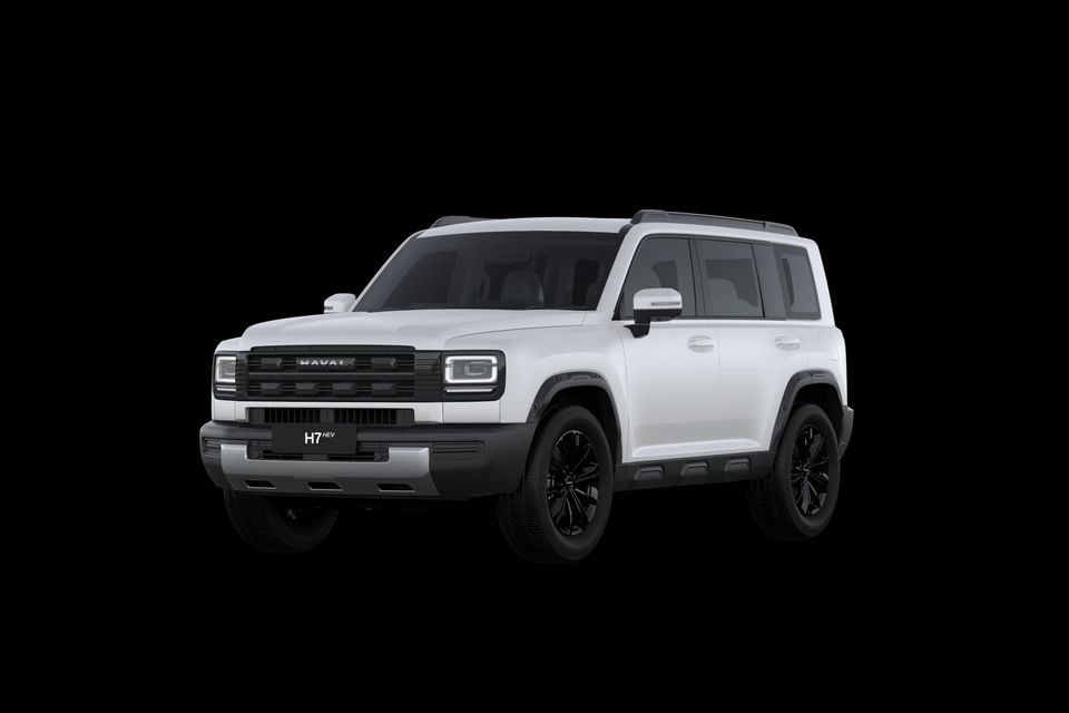 A white 2027 GWM Haval H7 HEV SUV with black wheels, seen from the front left against a black background.