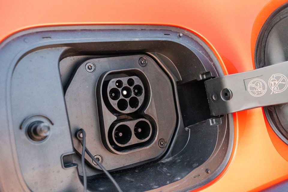 Close-up of a CCS Type 2 combined charging port on an orange GWM Tank 300 Ultra PHEV
