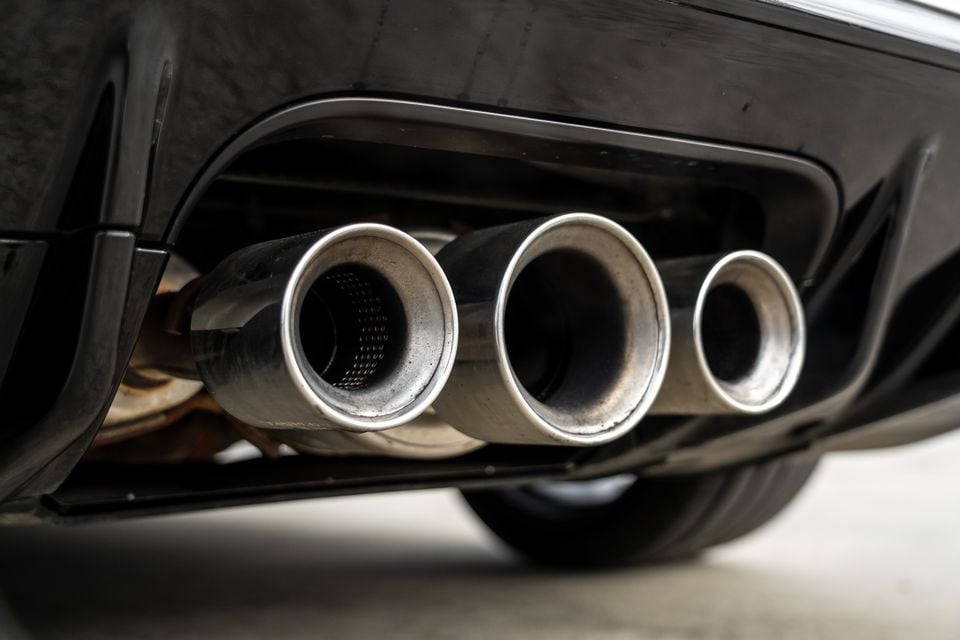 Close-up of the triple exhaust tips on the rear bumper of a Honda Civic Type R