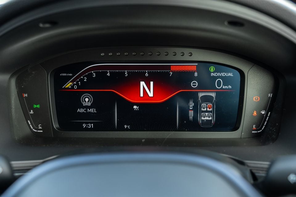 Digital instrument cluster of a Honda Civic Type R showing a rev counter, neutral gear indicator, speedometer reading 0 km/h, DAB radio tuned to ABC MEL, and individual drive mode selected