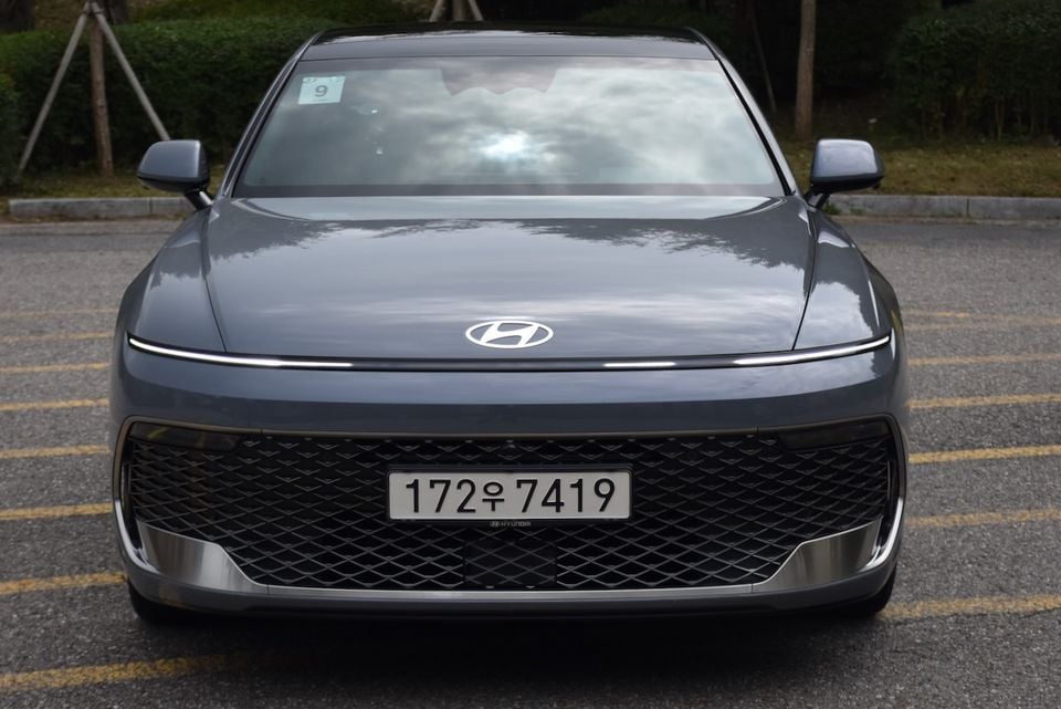 Front view of a grey Hyundai Grandeur sedan parked in a car park