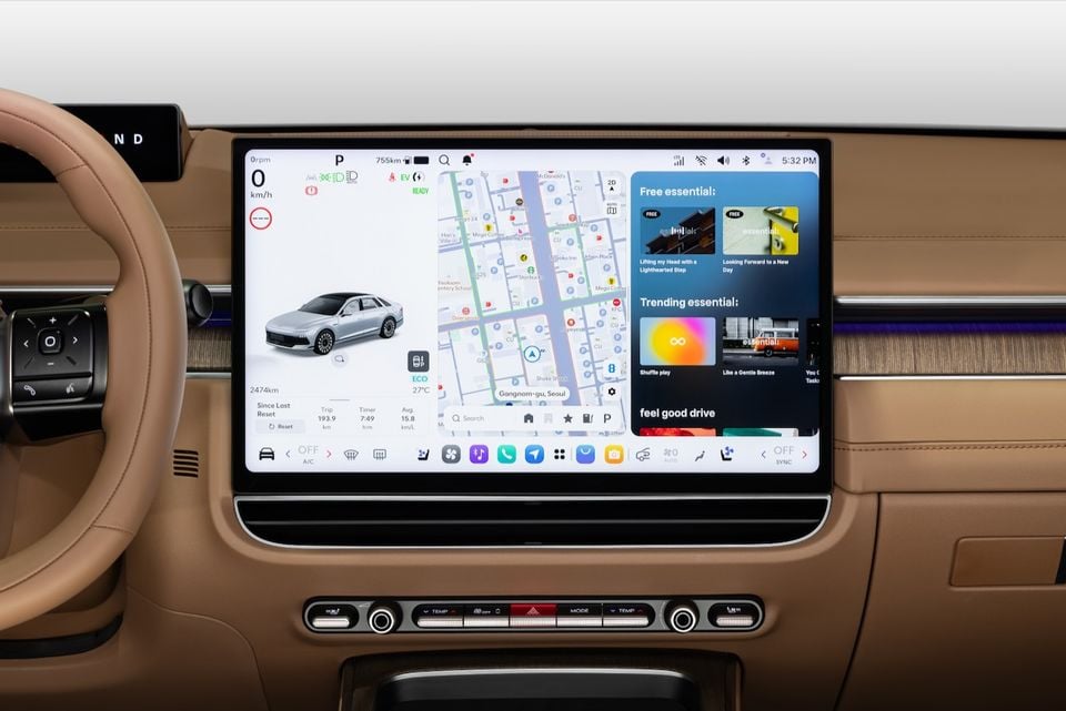 The large touchscreen infotainment display of the 2027 Hyundai Grandeur, showing navigation, vehicle status, and media controls in a tan leather interior