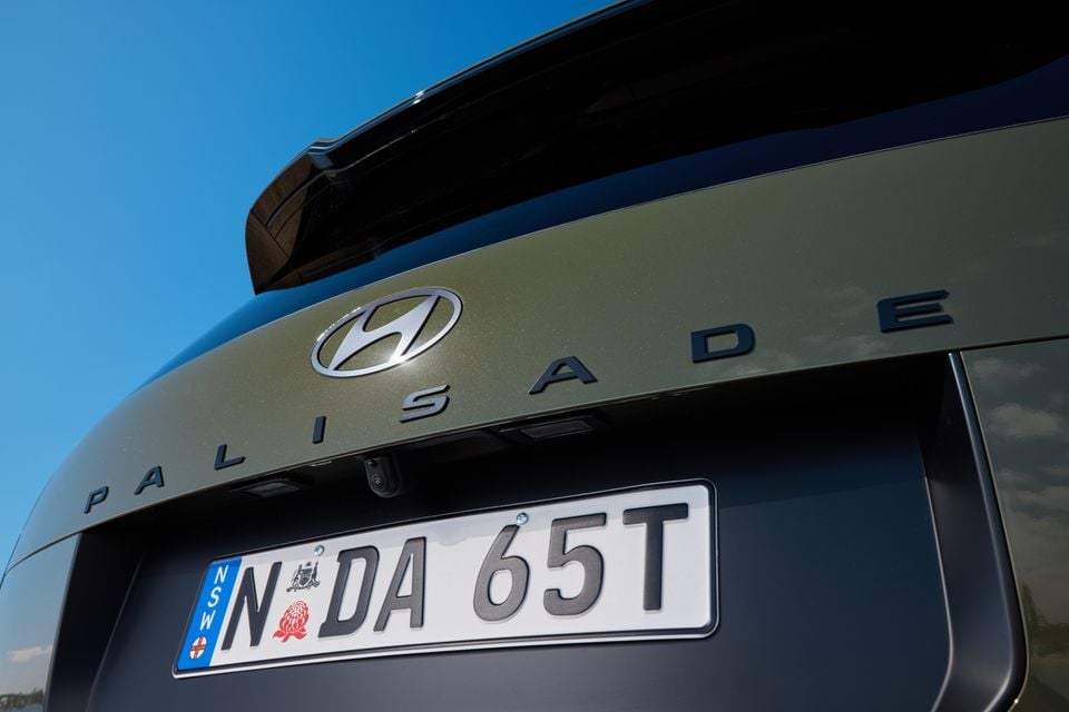 Close-up of the rear of a Hyundai Palisade SUV showing the Hyundai badge, Palisade lettering, rear camera, and a NSW number plate