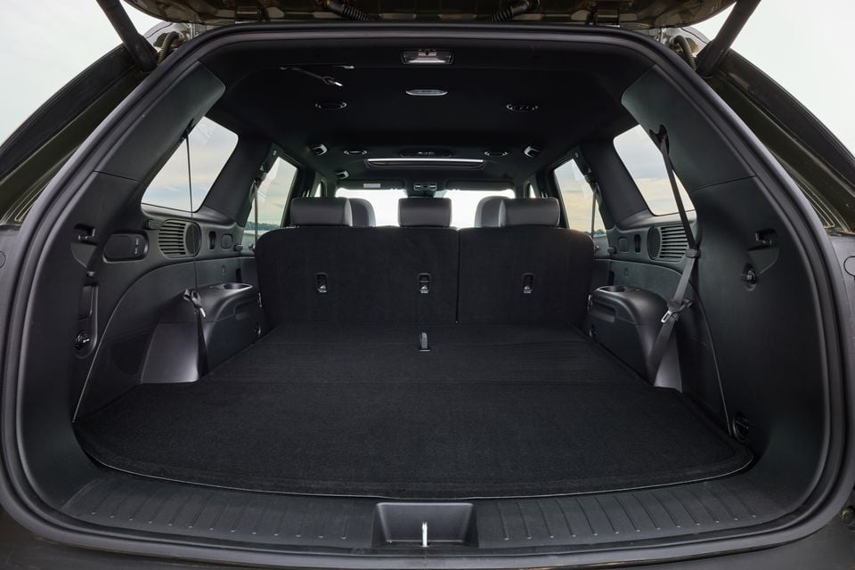 The open boot of a 2027 Hyundai Palisade XRT Pro SUV, showing a large carpeted cargo area with the third row visible in the background.