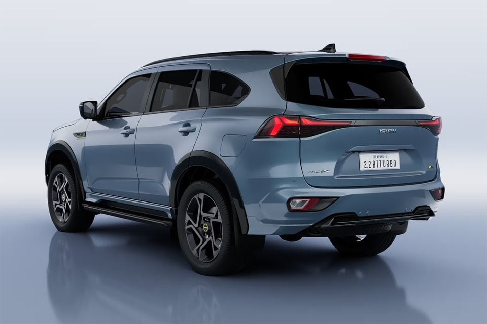Blue-grey 2027 Isuzu MU-X facelift SUV in a studio, seen from the rear and side, with a 2.2 Biturbo display number plate