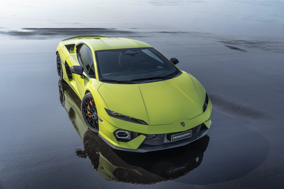 A lime green Lamborghini Temerario sports car photographed from above on a reflective wet surface, shown from the front quarter view.