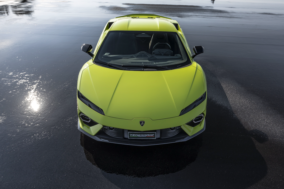 A lime green Lamborghini Temerario supercar photographed from directly above the front, parked on a wet dark surface