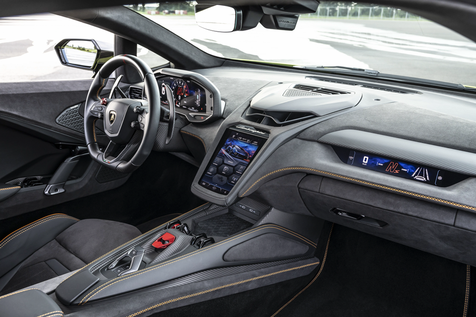 The interior of a 2027 Lamborghini Temerario, showing the steering wheel, digital instrument cluster and central touchscreen console.