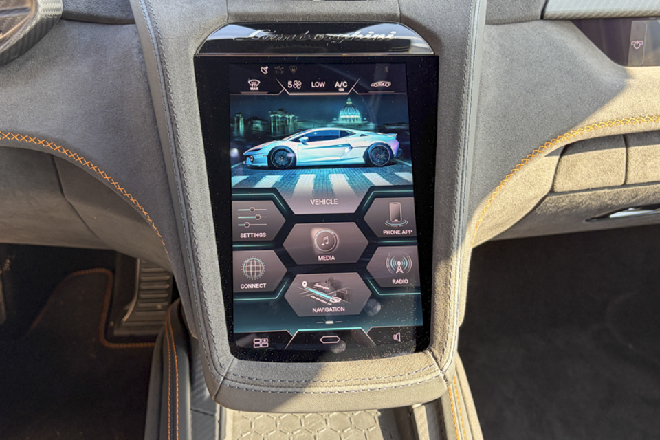 A portrait touchscreen infotainment display in a Lamborghini Temerario, showing the vehicle home menu with climate and navigation options