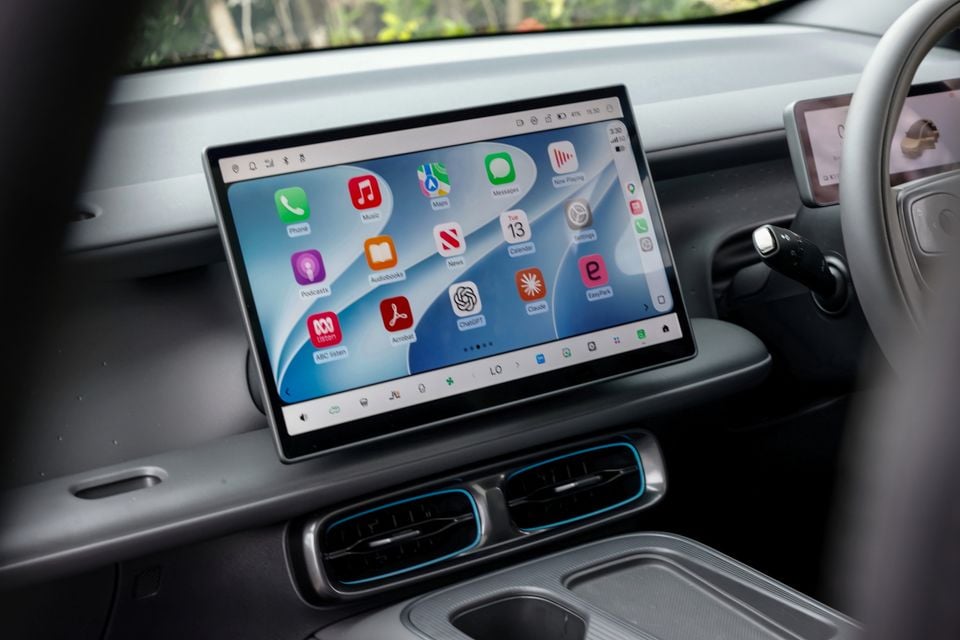 Infotainment touchscreen in the 2027 Leapmotor B05 dashboard showing Apple CarPlay, with air vents and steering wheel nearby