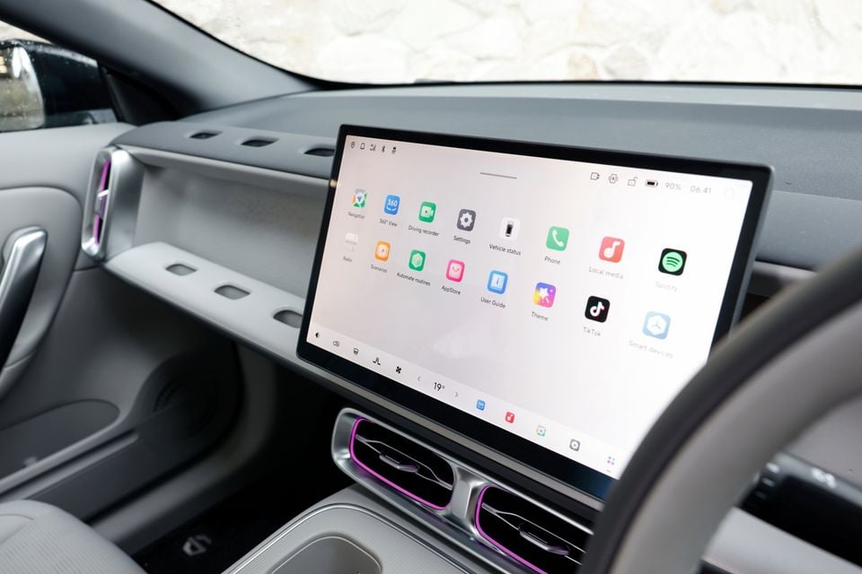 Large central touchscreen showing the app menu on the dashboard of a 2027 Leapmotor B05, with air vents below and the steering wheel at right