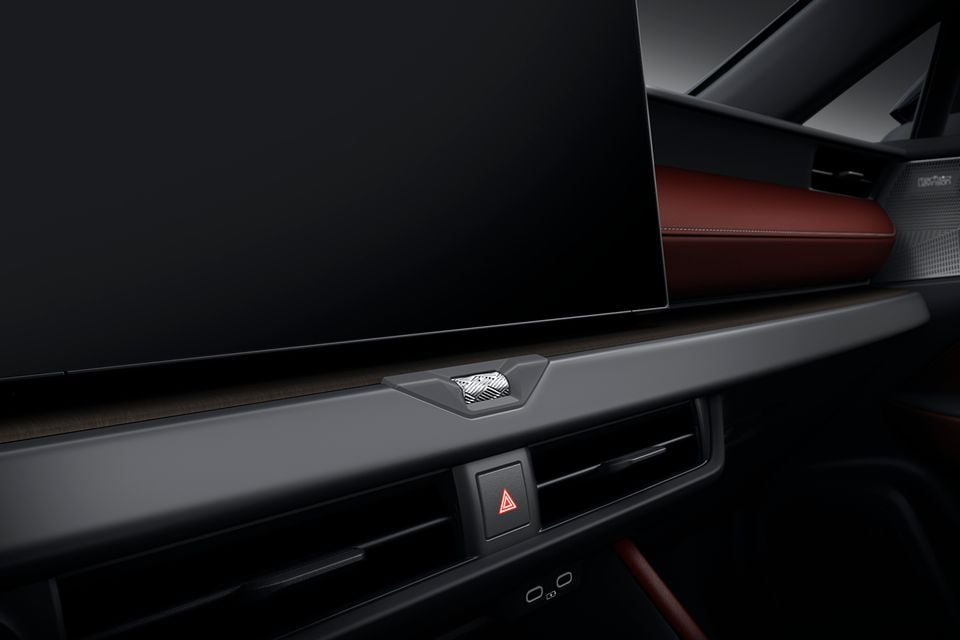 Interior of the 2027 Lexus NX facelift showing the large central touchscreen, hazard light button, air vents, and red leather seat trim