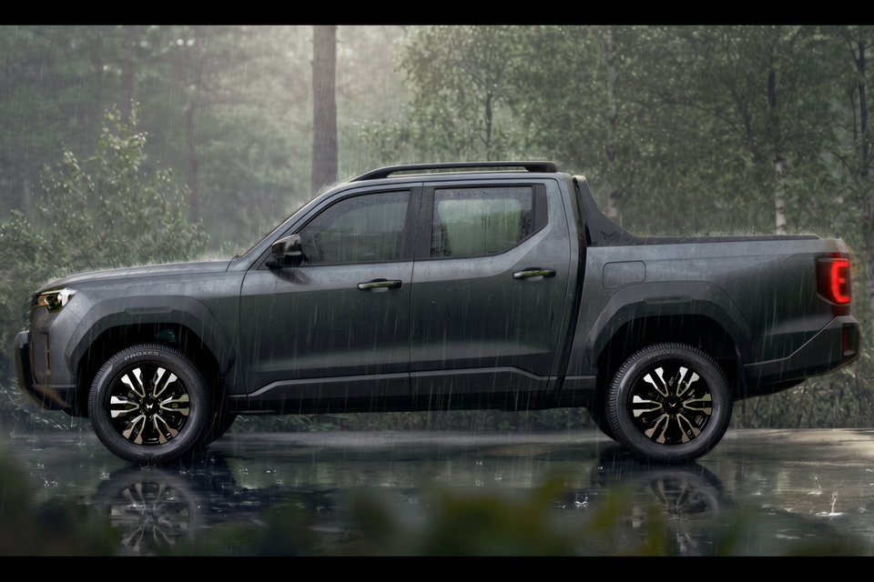 A dark grey Mahindra Lifestyler dual-cab ute seen from the side, parked in a rainy forest setting