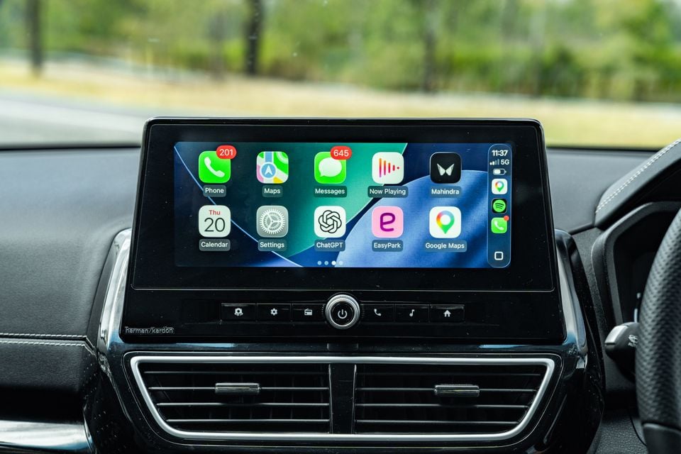 Apple CarPlay interface displayed on the touchscreen infotainment system of a Mahindra XUV 3XO, showing apps including Phone, Maps, Messages, ChatGPT, and Google Maps, with Harman/Kardon branding visible below the screen
