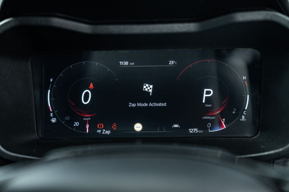 Digital instrument cluster of the Mahindra XUV 3XO showing 'Zap Mode Activated' with a chequered flag icon, speedometer reading zero, and gear selector in Park