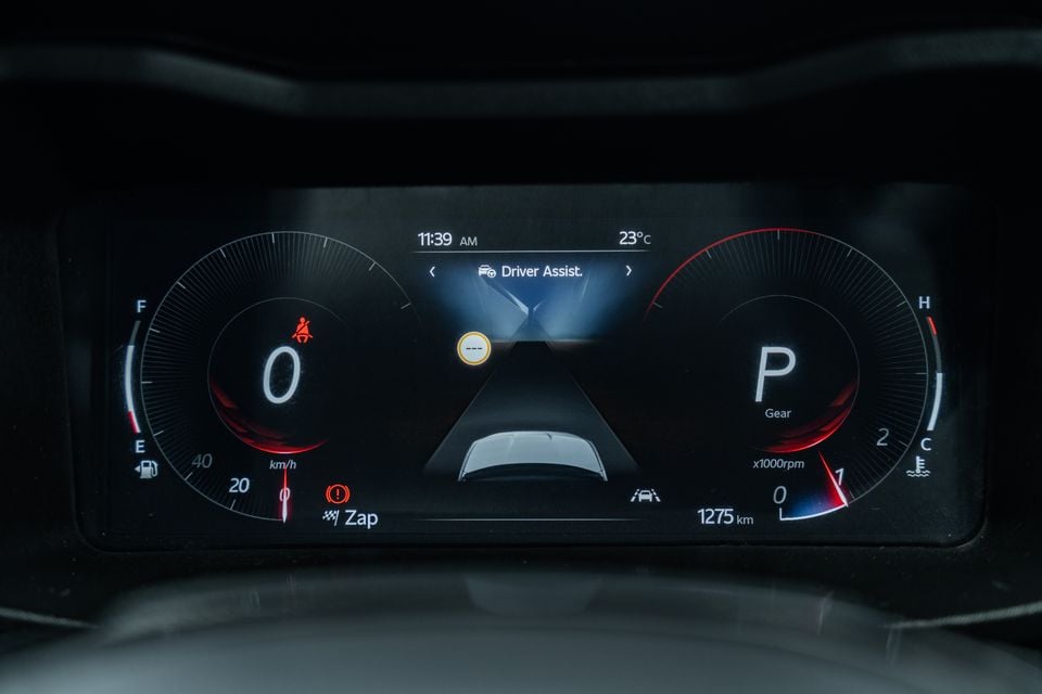 Digital instrument cluster in a Mahindra XUV 3XO showing speedometer, tachometer, gear position and Driver Assist display