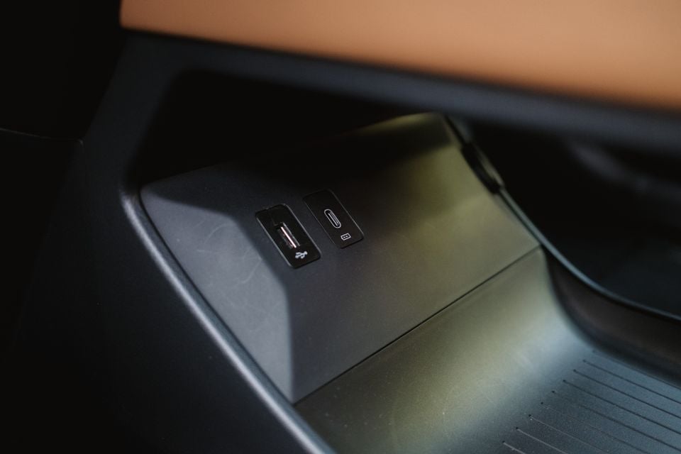 Close-up of USB-A and USB-C charging ports inside a storage compartment in a 2027 Mazda 6e Atenza