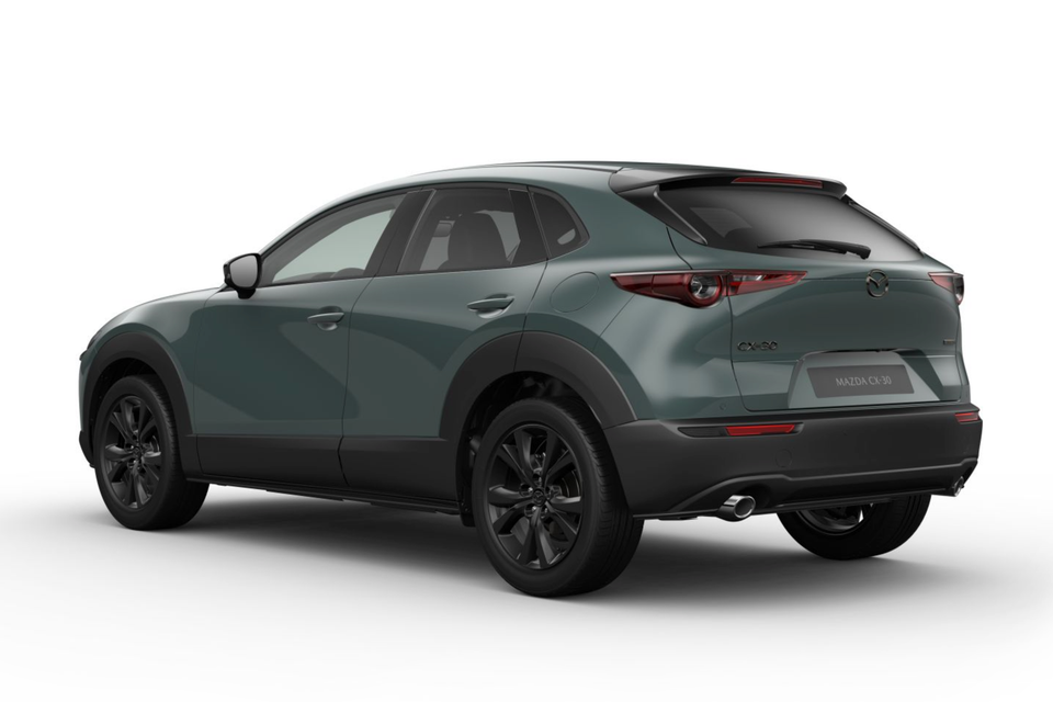 A green-grey 2027 Mazda CX-30 small SUV with black wheels, seen from the rear driver's side against a white background