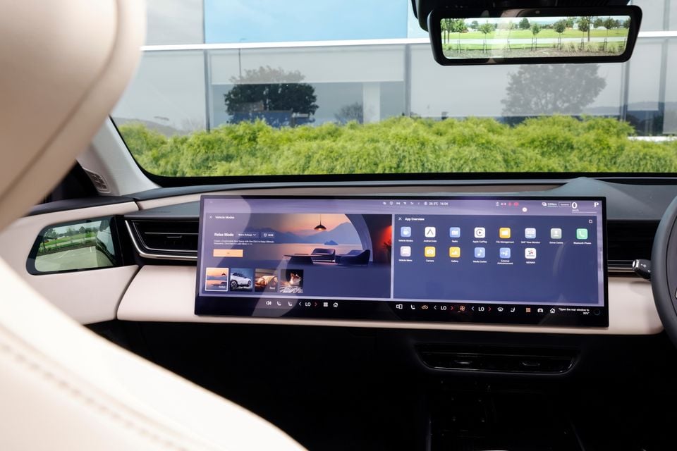 A large horizontal touchscreen infotainment display dominates the dashboard of a 2027 Mazda CX-6e, showing vehicle mode and app menus.