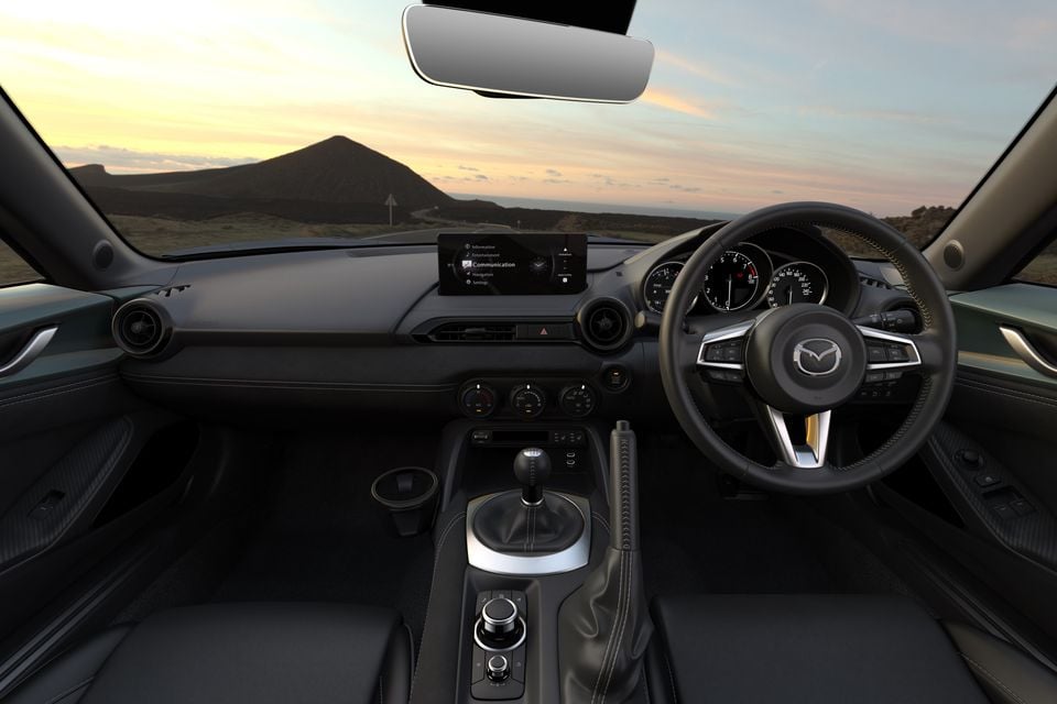 Dashboard of the 2027 Mazda MX-5 RF GT RS with a right-hand-drive steering wheel, central touchscreen and manual gear shifter