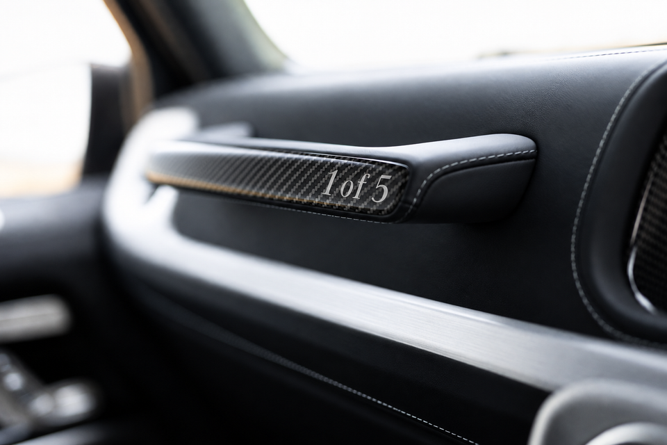 A carbon fibre trim panel on the dashboard of a Mercedes-AMG G63 Two Finish Edition, engraved with '1 of 5' indicating a limited production run.