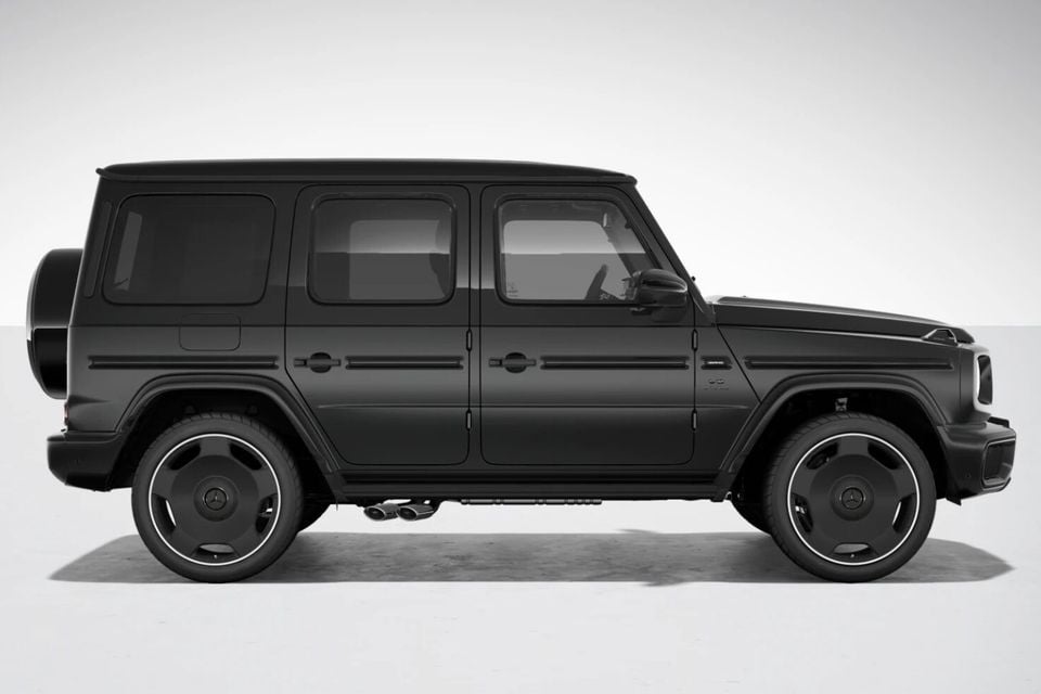 A black Mercedes-AMG G63 SUV seen from the side against a studio background