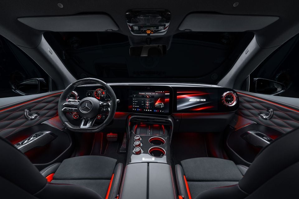 Dashboard of the 2027 Mercedes-AMG GT SUV with AMG steering wheel, wide touchscreens, carbon-fibre console and red ambient lighting