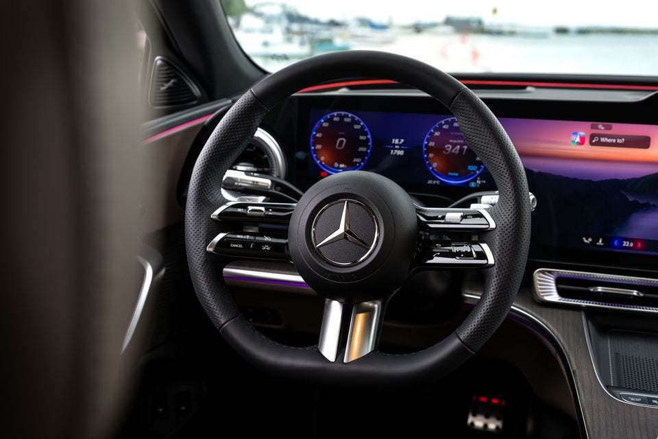 Mercedes-Benz steering wheel and digital instrument cluster inside the 2027 Mercedes-Benz C-Class Electric, with an infotainment screen visible to the right