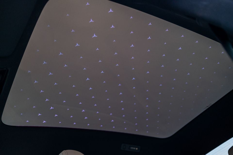 Mercedes-Benz star-pattern ambient lighting on the interior roof lining of the 2027 Mercedes-Benz C-Class Electric, with illuminated three-pointed star logos scattered across the headliner
