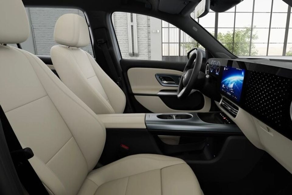 Beige leather front seats, steering wheel and widescreen digital dashboard inside the 2027 Mercedes-Benz GLB, seen from the passenger side