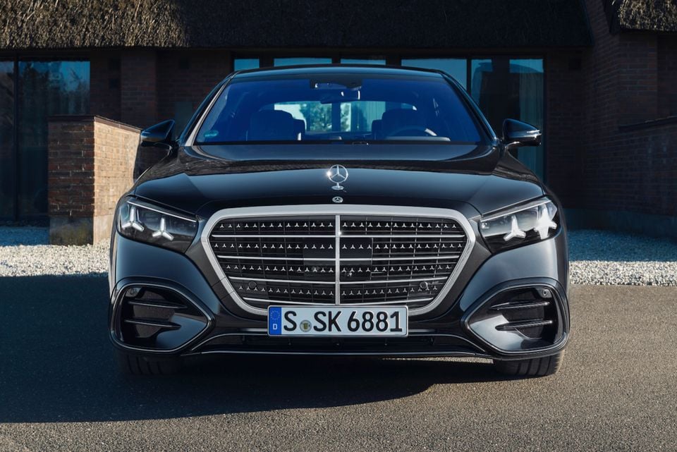 A black Mercedes-Benz S-Class sedan parked facing the camera, showing its front grille and headlights