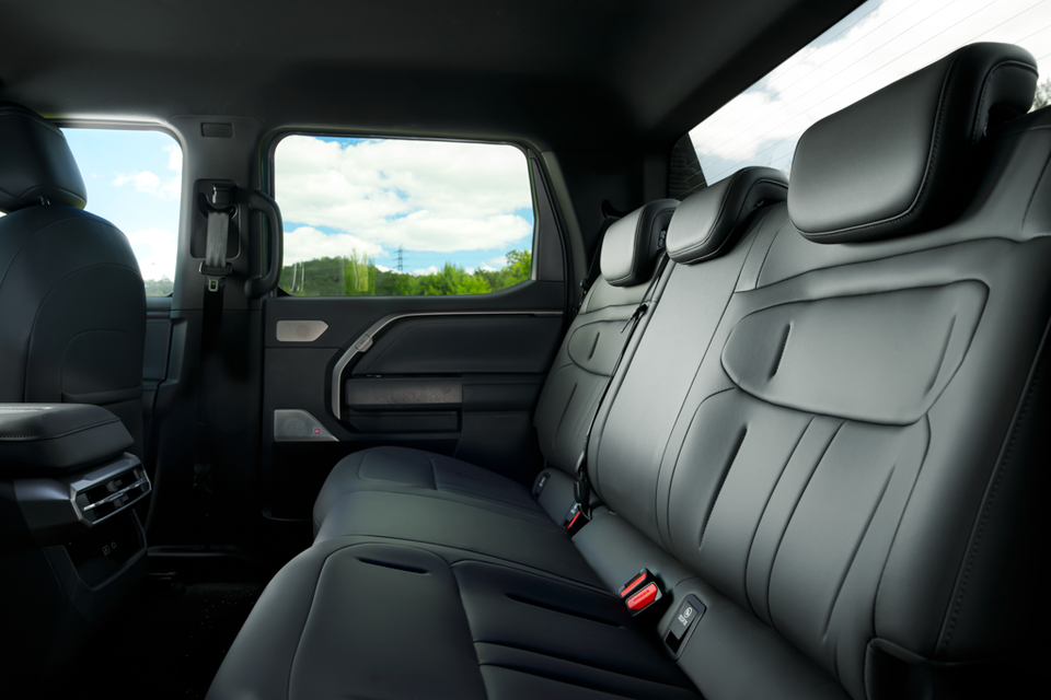 Rear seat row of the 2027 MG U9 EV dual-cab ute, with black leather upholstery and rear air vents behind the front seats