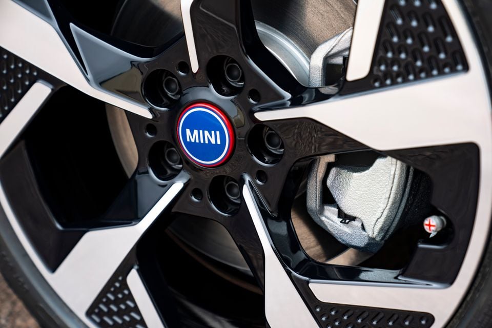 Close-up of a MINI alloy wheel showing the brand's blue centre cap and brake caliper detail