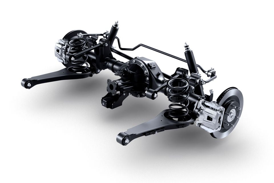 A rear suspension assembly with coil springs, shock absorbers, control arms, disc brakes and calipers, shown on a white background