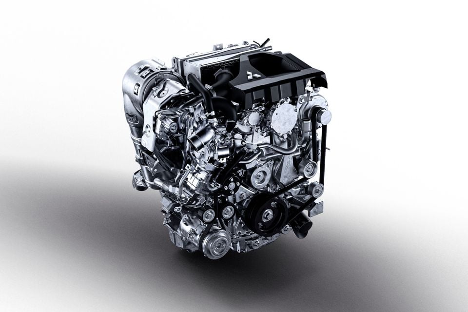 A Mitsubishi turbocharged engine displayed on a white studio background