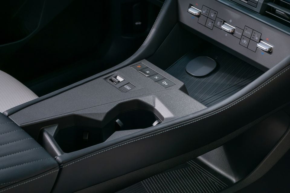 Interior centre console of the 2027 Nissan Rogue Hybrid, showing electronic gear selector buttons, cup holders, and climate control switches