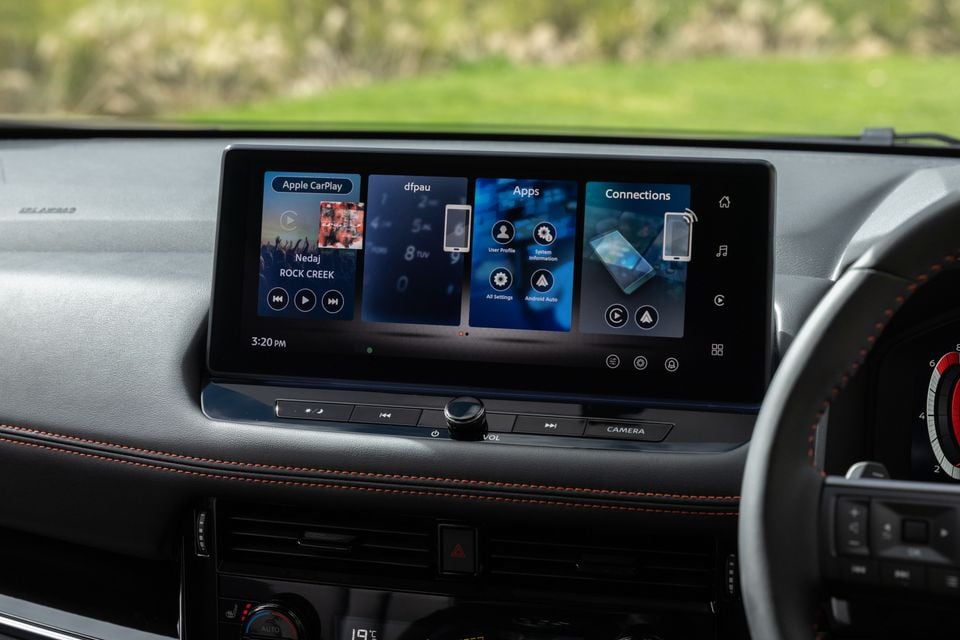 Close-up of the infotainment touchscreen in a 2027 Nissan X-Trail, showing Apple CarPlay, apps and connection menus