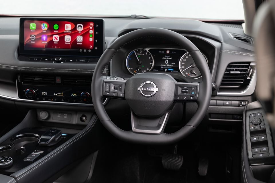 The steering wheel, dashboard and touchscreen inside a 2027 Nissan X-Trail ST-L e-Power