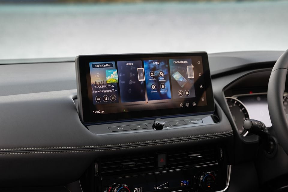 Close-up view of the touchscreen infotainment display and climate controls in a 2027 Nissan X-Trail