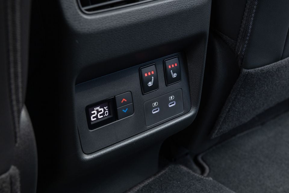 Close-up of the rear climate control panel and USB-C charging ports in a 2027 Nissan X-Trail, with seat heating switches above