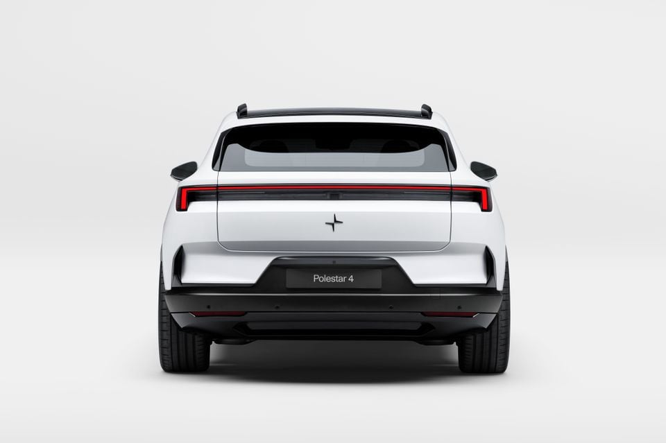 Rear view of a white Polestar 4 SUV on a white studio background, showing its full-width tail-light bar and Polestar logo