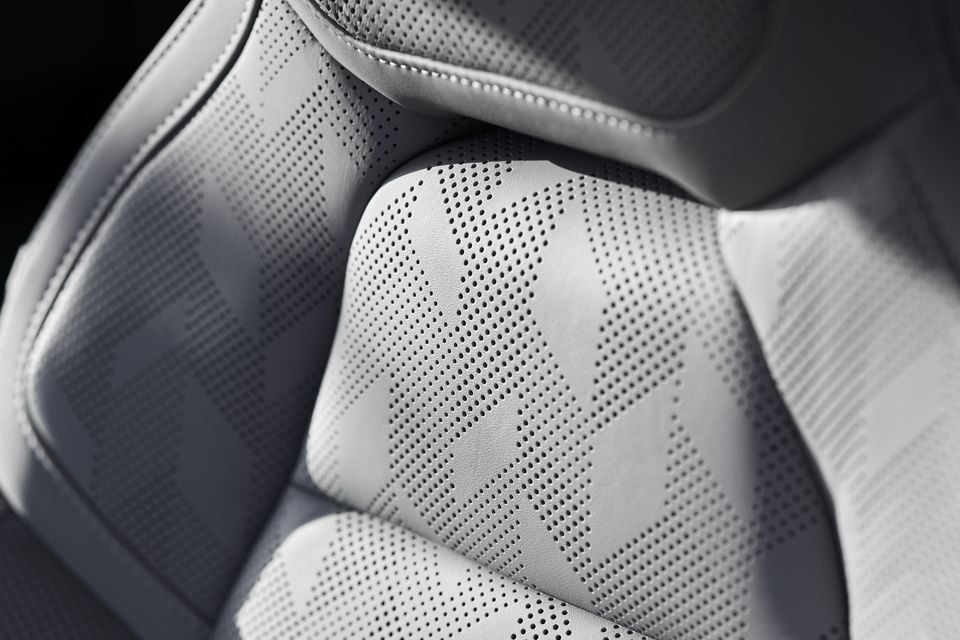 Close-up of a light grey perforated leather seat with a geometric pattern in the 2027 Polestar 4 SUV