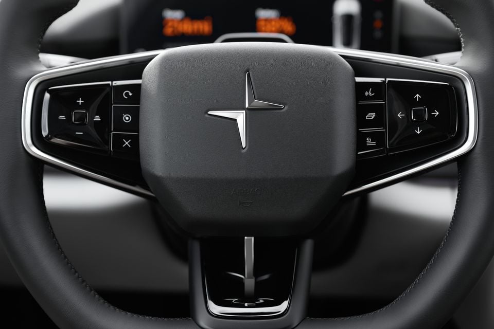 Steering wheel of the 2027 Polestar 4 dual-motor SUV with the Polestar logo on the airbag and control buttons on each spoke