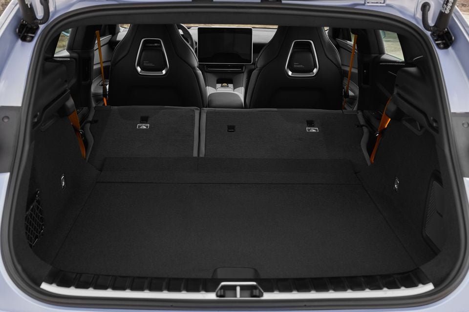 Boot of a 2027 Polestar 4 with the rear seats folded flat, looking through to the front sport seats and central touchscreen