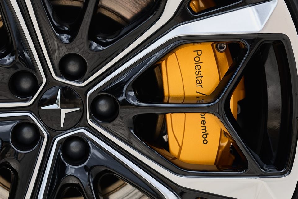 Close-up of a 2027 Polestar 4 alloy wheel with Polestar centre cap and yellow Polestar-branded Brembo brake caliper
