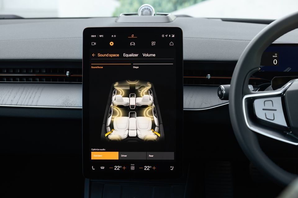 Portrait touchscreen in the 2027 Polestar 5 Performance showing the Sound space audio settings, with climate controls and the steering wheel beside it
