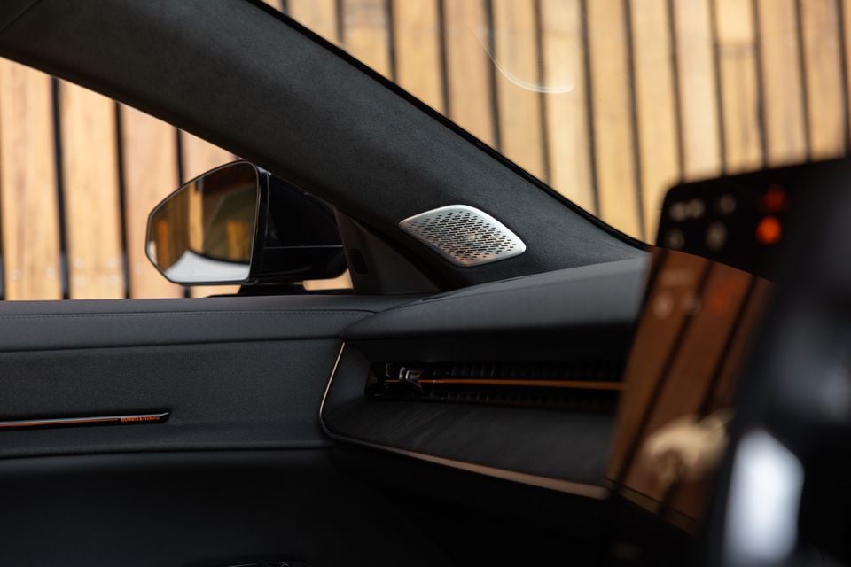 Bowers & Wilkins tweeter on the A-pillar of a 2027 Polestar 5 Performance, with the dashboard air vent and side mirror visible