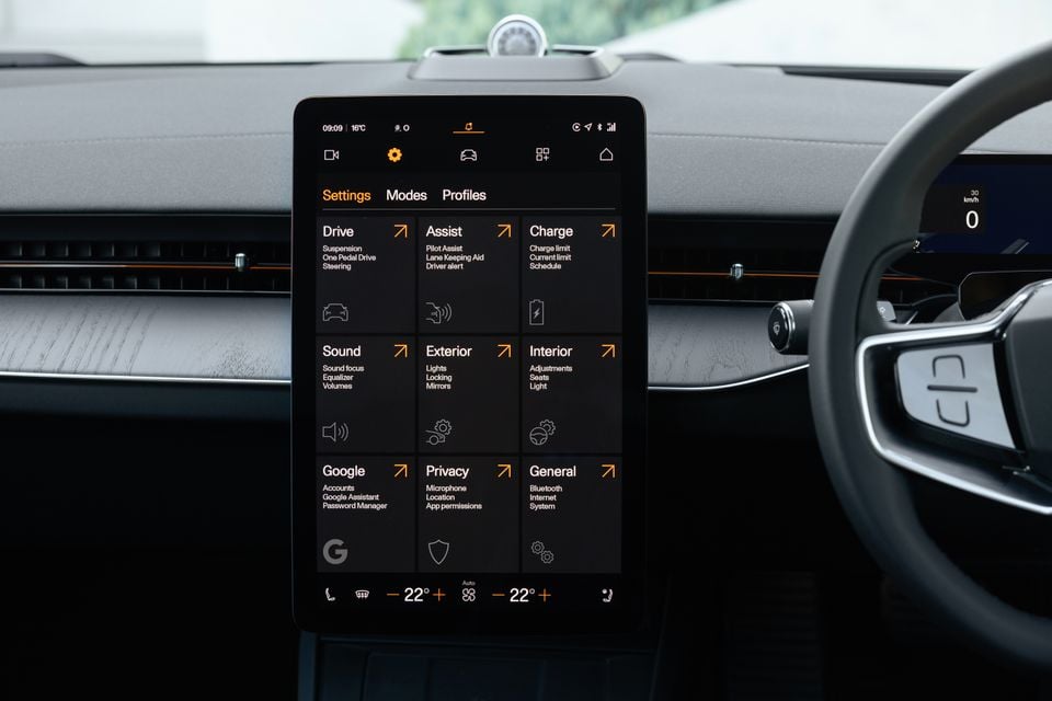 Portrait-style touchscreen in the 2027 Polestar 5 dashboard showing the settings menu, with climate controls along the bottom and the steering wheel at right