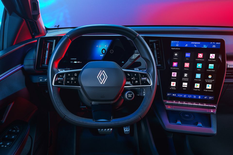 Dashboard of the 2027 Renault Megane E-Tech Esprit Alpine with a steering wheel, digital driver display and large portrait touchscreen showing apps