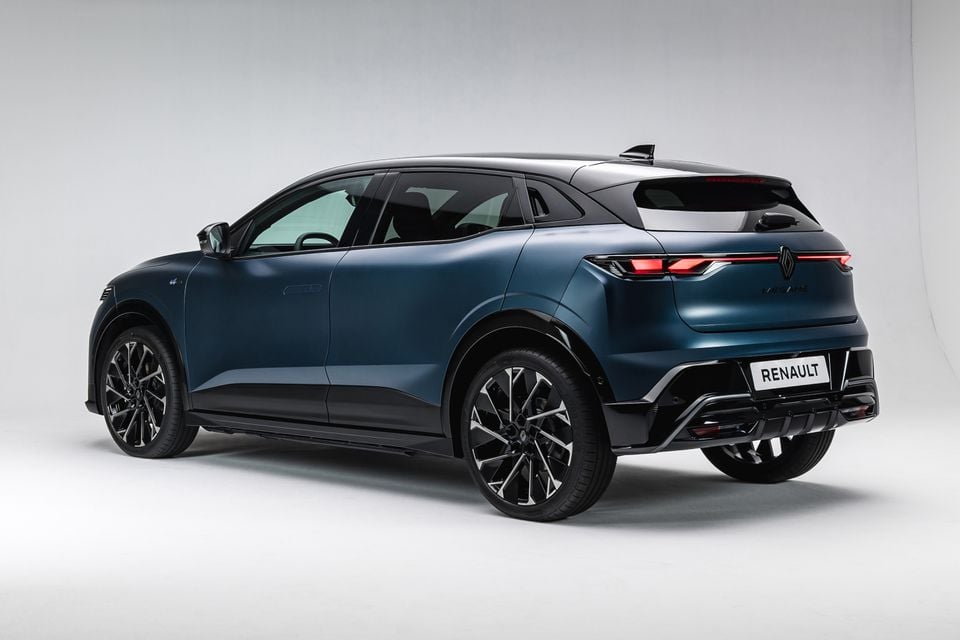 A dark blue 2027 Renault Megane E-Tech Esprit Alpine electric SUV seen from the rear three-quarter angle in a white studio